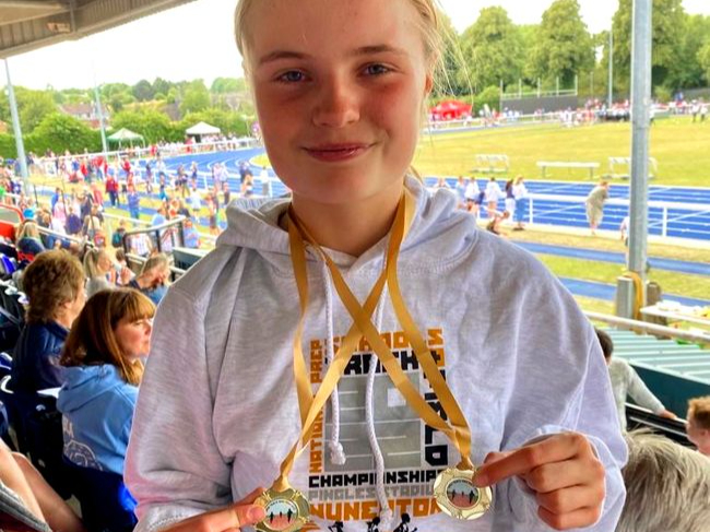 Highfield & Brookham Schools pupil Emily Sherlock, 12, with the 100m and long jump gold medals she won at the National Prep Schools Athletics Championships at the Alexander Stadium in Birmingham, July 2022.