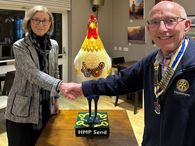 Haslemere Rotary president Paul Mills, right, presents the hen to Sally Varah