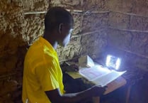 Volunteer from Liphook helps Kenyan children do their homework