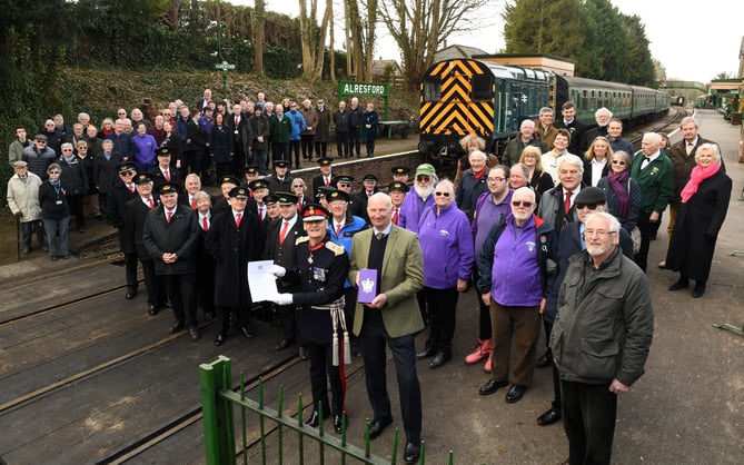 Volunteers who help maintain nd run the Watercress heritage railway that runs between Alresford and Alton in Hampshire have been awarded the Kings Award for volunteering.
 Pictured: Watercress President Richard Lacey holds the award whilst the Lord Lietenant for Hampshire Higel Atkinson holds the certificate awarded to the volunteers.Â©Russell SAch - 0771 882 6138
