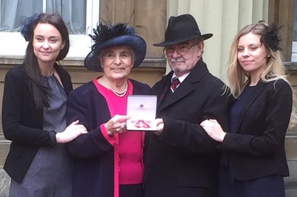 Janet Maines MBE with partner Victor and granddaughters Talor (left) and Roxanne at Buckingham Palace