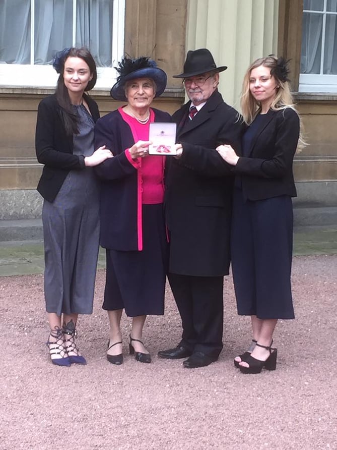Janet Maines MBE with partner Victor and granddaughters Talor (left) and Roxanne at Buckingham Palace