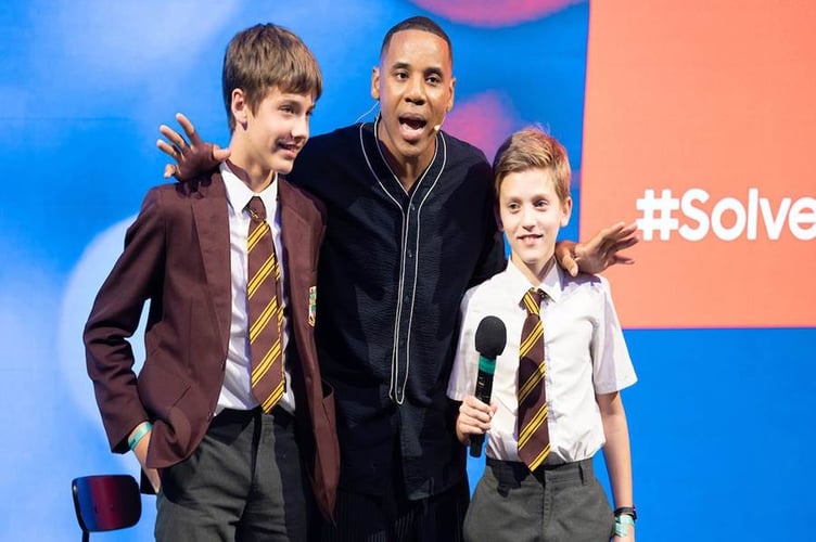 2022 Solve for Tomorrow: Next Gen winner Alek and runner-up Filip (age 11-13 category) with Reggie Yates