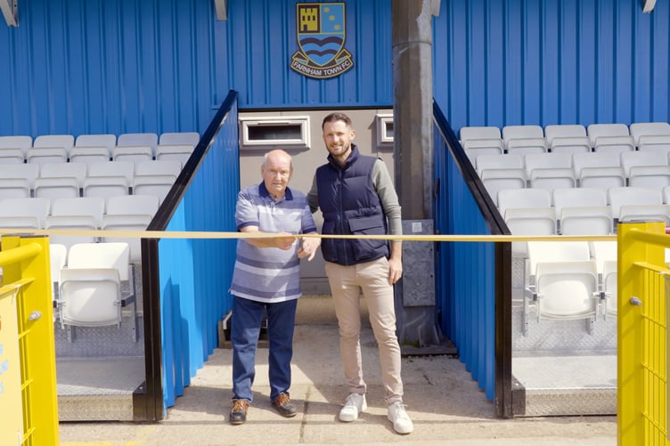 Long-time Farnham supporter Ray White cuts the ribbon to officially open the SO Resi Family Stand alongside commercial director Ed Kelsing