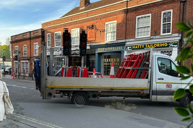 The view from Veena's Kitchen in South Street as Surrey highways workers block off the road for emergency pothole repairs – trapping many motorists in the town centre