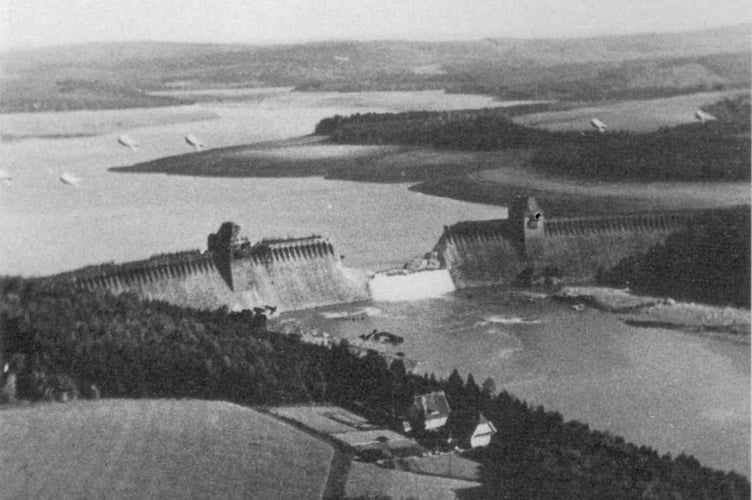 This photograph of the breached Möhne Dam was taken by Flying Officer Jerry Fray of No. 542 Squadron from his Spitfire PR IX. Six barrage balloons can be seen above the dam.