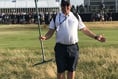 Alton Golf Club greenkeeper Darren Miller rakes bunkers at The Open