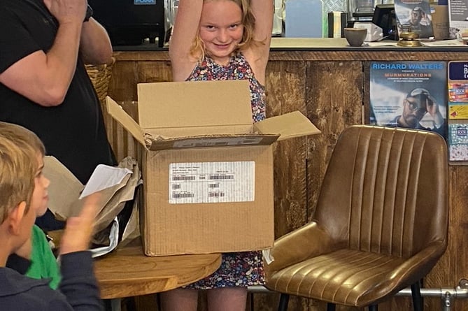 Daisy Shrimpton-Mace, 9, from Alton, holds her novel aloft at the Goldfinch Books launch