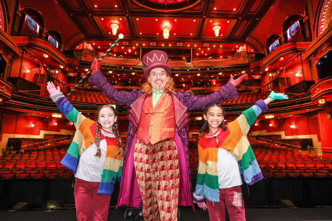 Gareth Snook as Willy Wonka with Jessie-Lou Harvie, left, and Harmony Raine-Riley, who played Charlie Bucket in Charlie and the Chocolate Factory – The Musical, Mayflower Theatre, Southampton, August 2023.