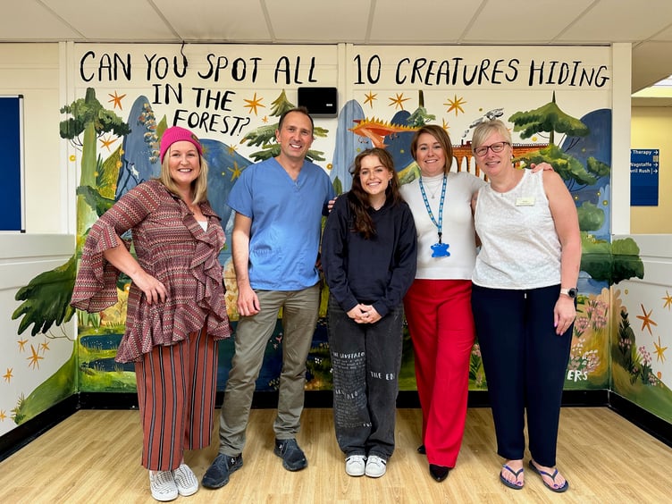 Unveiling of mural in children's waiting room at The Wilson Practice, Alton, October 2023. From left: Ríana Gallagher, Dr Oliver Kemp, Flossy Waters, Rachael Sowerby and reception manager Sharon Stevens