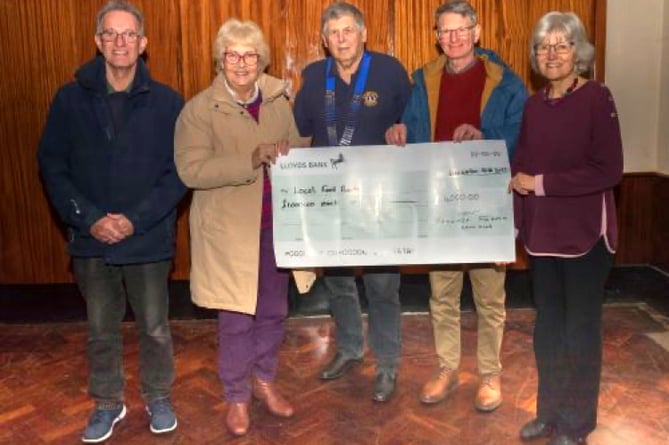 Woolmer Forest Lions acting president Richard Balchin hands over a £4,000 cheque to four local foodbanks. Pictured from left to right: Martin Firman (representing Bordon Foodbank), Pauline Firman (Headley Down Foodbank), Richard Balchin (Woolmer Forest Lions), Nigel Drury (Liss Foodbank) and Mary Braitch (Liphook Foodbank)