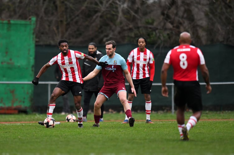 Harry Cooksley competes for possession at Guildford City