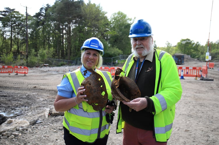 Justine Hope, Site Manager at Bellway’s Perceval Grange, and Dave Rudwick, local historian, with WW2 helmets from  Midhurst Society