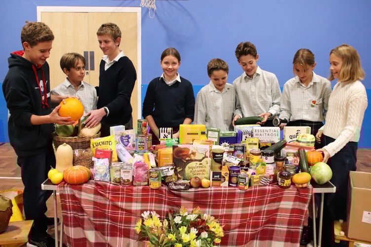 Highfield and Brookham children size up the harvest festival goodies which will be heading to Liphook Community Centre