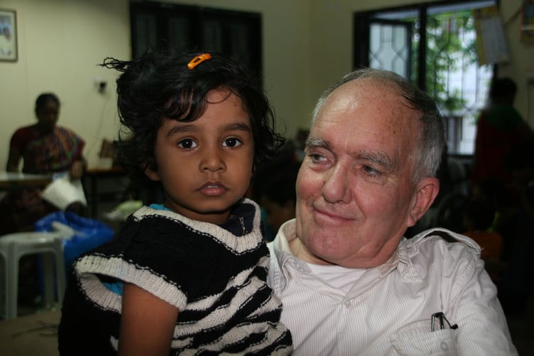 Robin Radley with a child at the Chiks charity in Kerala.