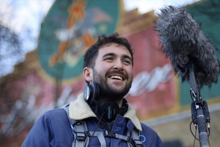 Luke on a film set with his sound equipment