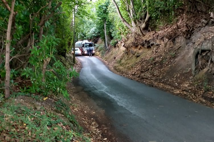 A Thames Water tanker squeezes past a stranded car on Chase Lane after a minor crash on Sunday, July 6 – with larger tankers forced to wait as Haslemere’s water supply hung in the balance