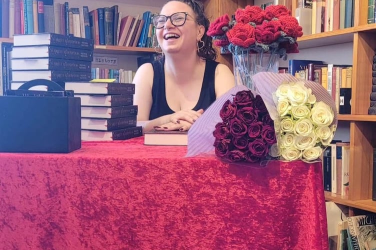 Freedom Matthews signs limited edition copies of Scarlett Redemption at Haslemere Bookshop during the book launch 