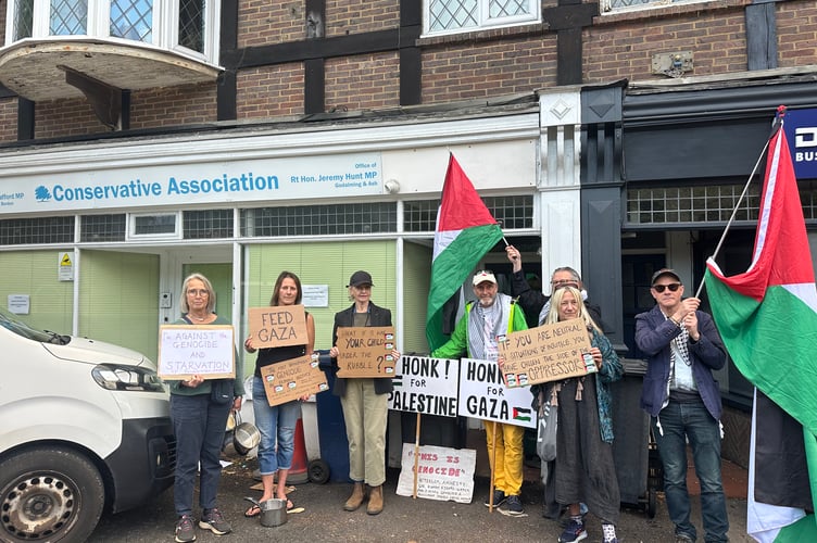 Protesters gathered outside the Hindhead offices of MPs Jeremy Hunt and Greg Stafford, demanding urgent action on Gaza