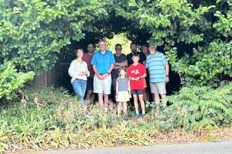 Residents gather outside the entrance to Nicols Field, where plans for new allotments have sparked anger over a lack of consultation
