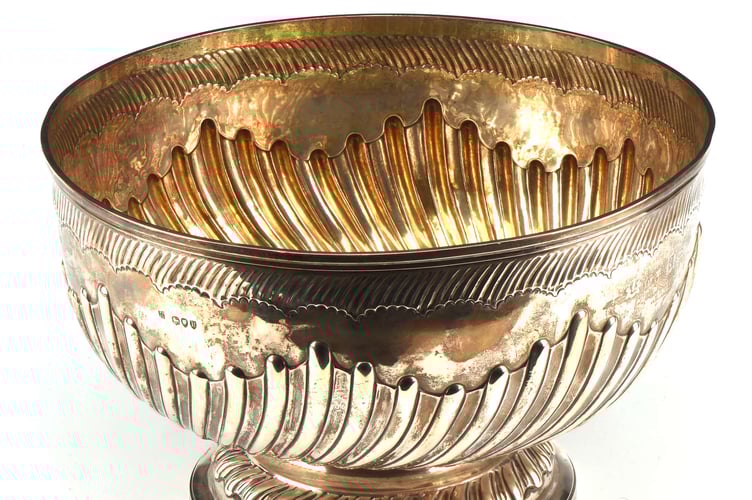Late-Victorian spiral fluted punch bowl on pedestal foot by The Goldsmiths & Silversmiths Company.