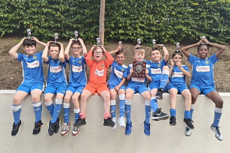 Liphook United’s young players celebrating a brilliant season with their hard-earned trophies. The club says the break-in has taken money directly from supporting moments like these