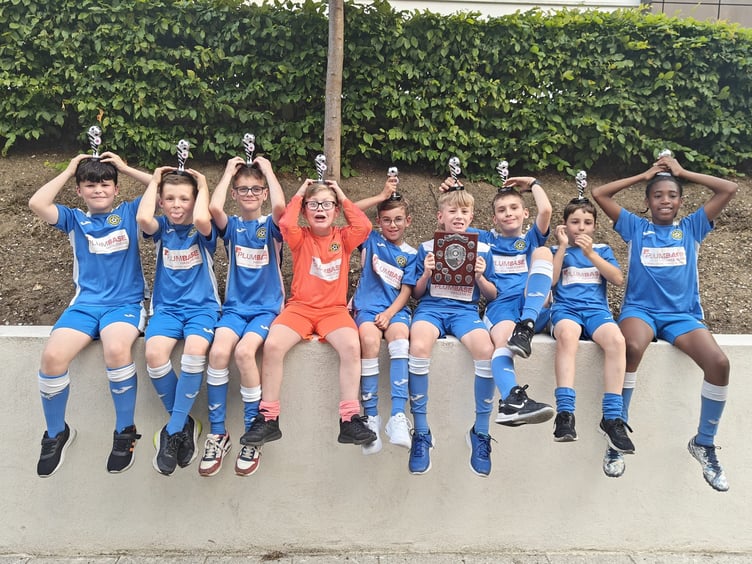 Liphook United’s young players celebrating a brilliant season with their hard-earned trophies. The club says the break-in has taken money directly from supporting moments like these