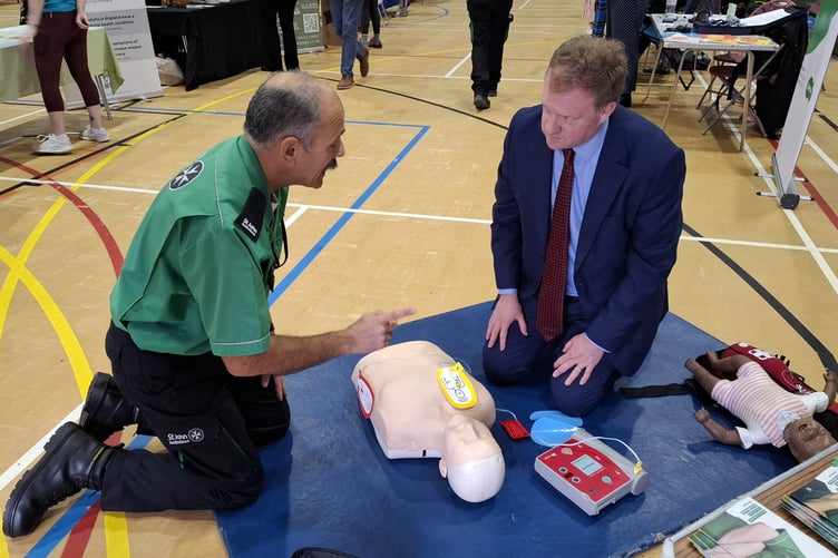 Greg Stafford MP learns about using a defibrillator from St John's ambulance at the health fair in Farnham.