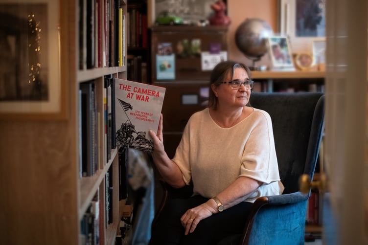Farnham resident Hilary Roberts with her book Camera at War: 170 Years of Weaponizing Photography.