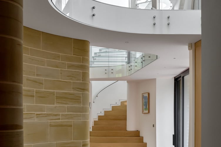 Downley House in South Downs National Park, near Petersfield, Hampshire. A house that was featured on Grand Designs has had to slash its price by a whopping Â£750,000 after failing to sell for 18 months.Downley House was listed for sale in July 2024 with a guide price of Â£5 million when owner Chris Taee decided it was time to sell up after 12 years in the property.Taee built the 7,374 sq ft oak-clad house from scratch, which boasts five bedrooms - three in the family wing and two guest bedrooms - five bathrooms and an oval-shaped central dining area with a 23ft high ceiling.The house was used by Kevin McCloud to host the Grand Designs House of the Year show there, whilst also being shortlisted for the RIBA House of the Year award.The property is built on 2.5 acres within a valley of South Downs National Park, near Petersfield, Hampshire.
