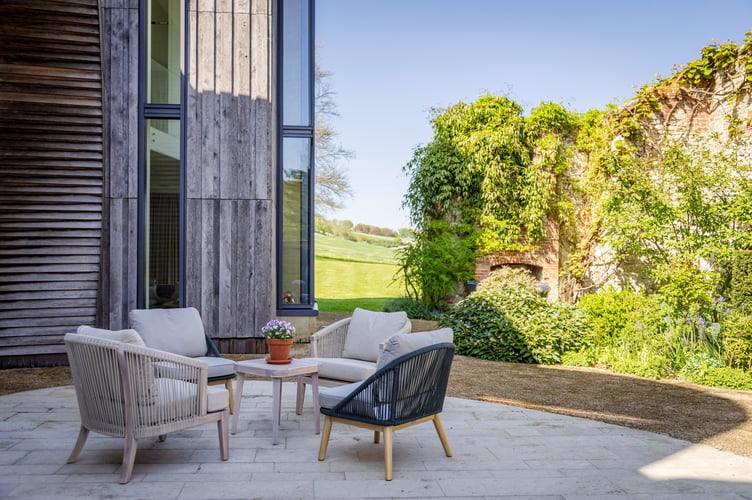 Downley House in South Downs National Park, near Petersfield, Hampshire. A house that was featured on Grand Designs has had to slash its price by a whopping £750,000 after failing to sell for 18 months.Downley House was listed for sale in July 2024 with a guide price of £5 million when owner Chris Taee decided it was time to sell up after 12 years in the property.Taee built the 7,374 sq ft oak-clad house from scratch, which boasts five bedrooms - three in the family wing and two guest bedrooms - five bathrooms and an oval-shaped central dining area with a 23ft high ceiling.The house was used by Kevin McCloud to host the Grand Designs House of the Year show there, whilst also being shortlisted for the RIBA House of the Year award.The property is built on 2.5 acres within a valley of South Downs National Park, near Petersfield, Hampshire.
