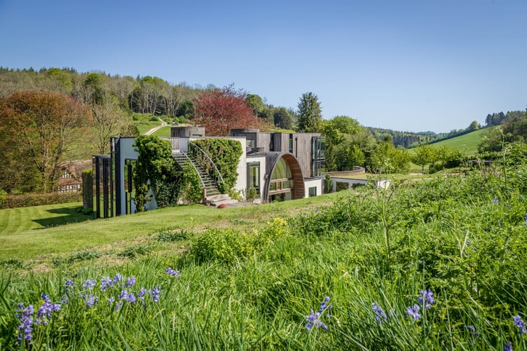 Downley House in South Downs National Park, near Petersfield, Hampshire. A house that was featured on Grand Designs has had to slash its price by a whopping £750,000 after failing to sell for 18 months.Downley House was listed for sale in July 2024 with a guide price of £5 million when owner Chris Taee decided it was time to sell up after 12 years in the property.Taee built the 7,374 sq ft oak-clad house from scratch, which boasts five bedrooms - three in the family wing and two guest bedrooms - five bathrooms and an oval-shaped central dining area with a 23ft high ceiling.The house was used by Kevin McCloud to host the Grand Designs House of the Year show there, whilst also being shortlisted for the RIBA House of the Year award.The property is built on 2.5 acres within a valley of South Downs National Park, near Petersfield, Hampshire.