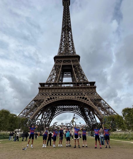 Phyllis Tuckwell cyclists celebrate their Farnham-to-Paris ride in front of the Eiffel Tower.