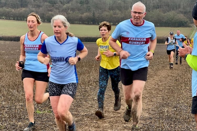 Farnham Runners Kelly Lincoln and Chris Gill speed up the final hill of the cross country