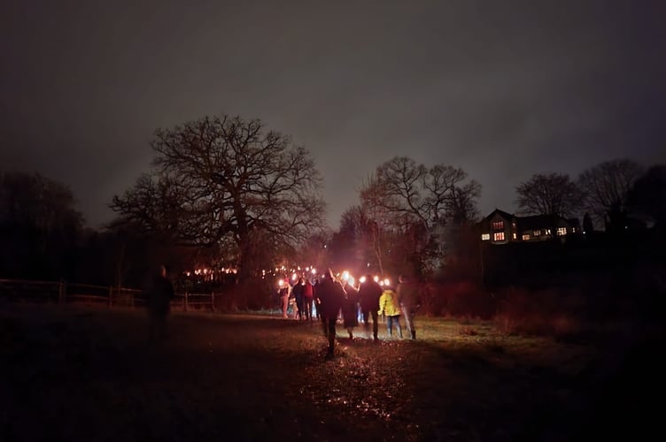 Torchlight procession leads revellers through Swan Barn orchards
