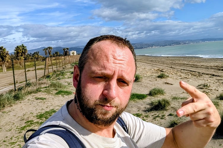 Aleksander Sikora in Malaga, Spain. A savvy travel-lover flew to Malaga for a day by the seaside for only £44 - taking just his passport, water bottle and a pack of sausage rolls.Aleksander Sikora, 41, fancied escaping rainy England for a day - and searched for budget flights.The dad-of-two snapped up £32 return flights to Malaga, Spain, and set off on January 31 from Gatwick, on his day off.He spent the day wandering around the nearby town of Guadalmar, strolling along the beach and enjoying sun and 19 degree heat.With a plan to keep the day trip as affordable as possible, he brought his own fuel - an eight-pack of sausage rolls bought from Lidl the day before, and a water bottle to refill throughout the day.
