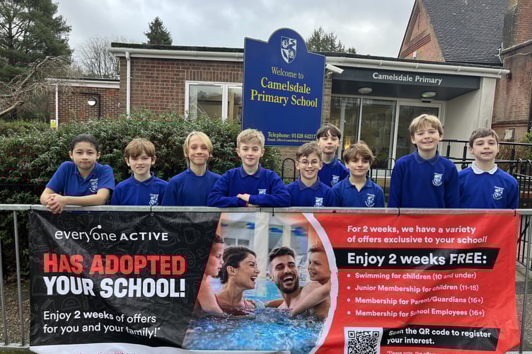 Sports Ambassadors with the Waverley Pool banner outside Camelsdale School.