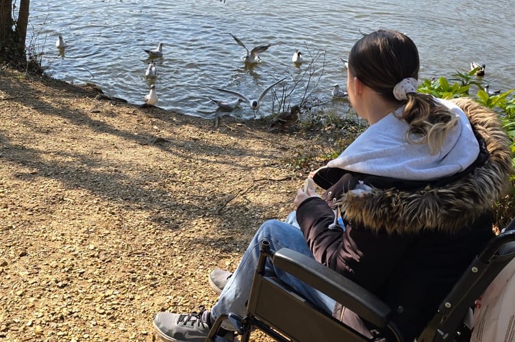 Chloe Ramsay out in her wheelchair.