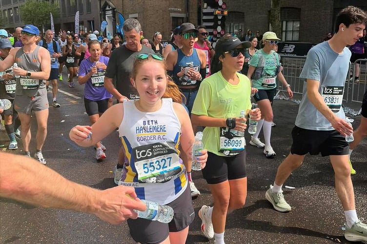 Beth Sutton hydrates at the 22-mile water station