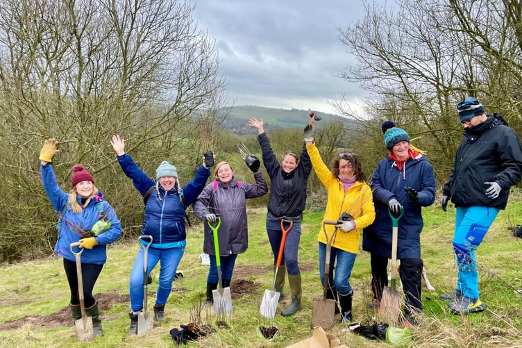Volunteers planting trees at Wild Heart Hill in South Downs National Park as part of ReNature initiative.