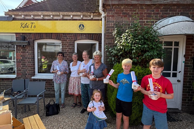 Liphook in Bloom chair Lesley Hollands presents certificates and prizes to this year’s competition winners, with youngsters among those celebrating their sunflower-growing success. Winners received mugs sponsored and made by Grayshott Pottery.