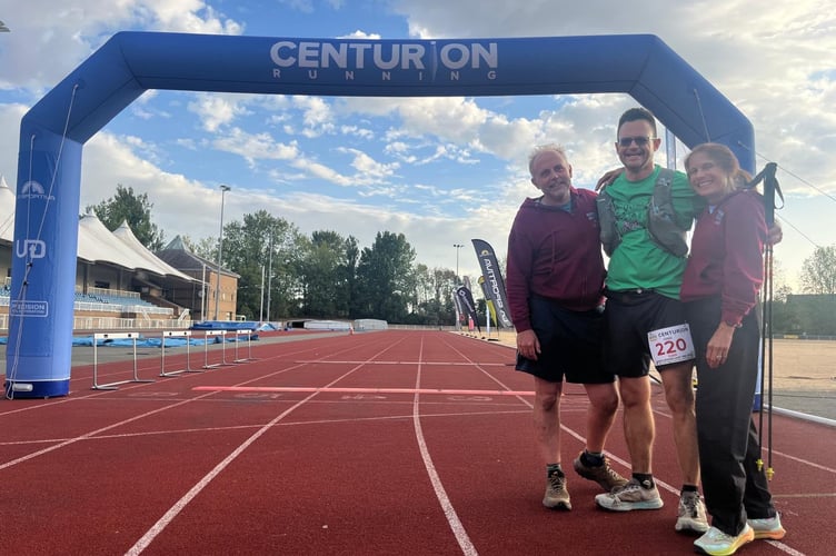 Ivan Chunnett crosses the finish line with his dedicated crew, Craig Tate-Grimes and Candy Waller, who played a vital part in achieving his goal